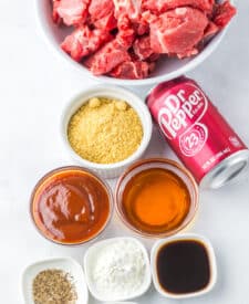 Ingredients for Dr Pepper steak bites including steak, Dr Pepper, seasonings, and sauce.