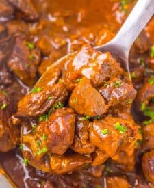 Tender Dr Pepper steak bites coated in a glossy sauce inside the slow cooker.