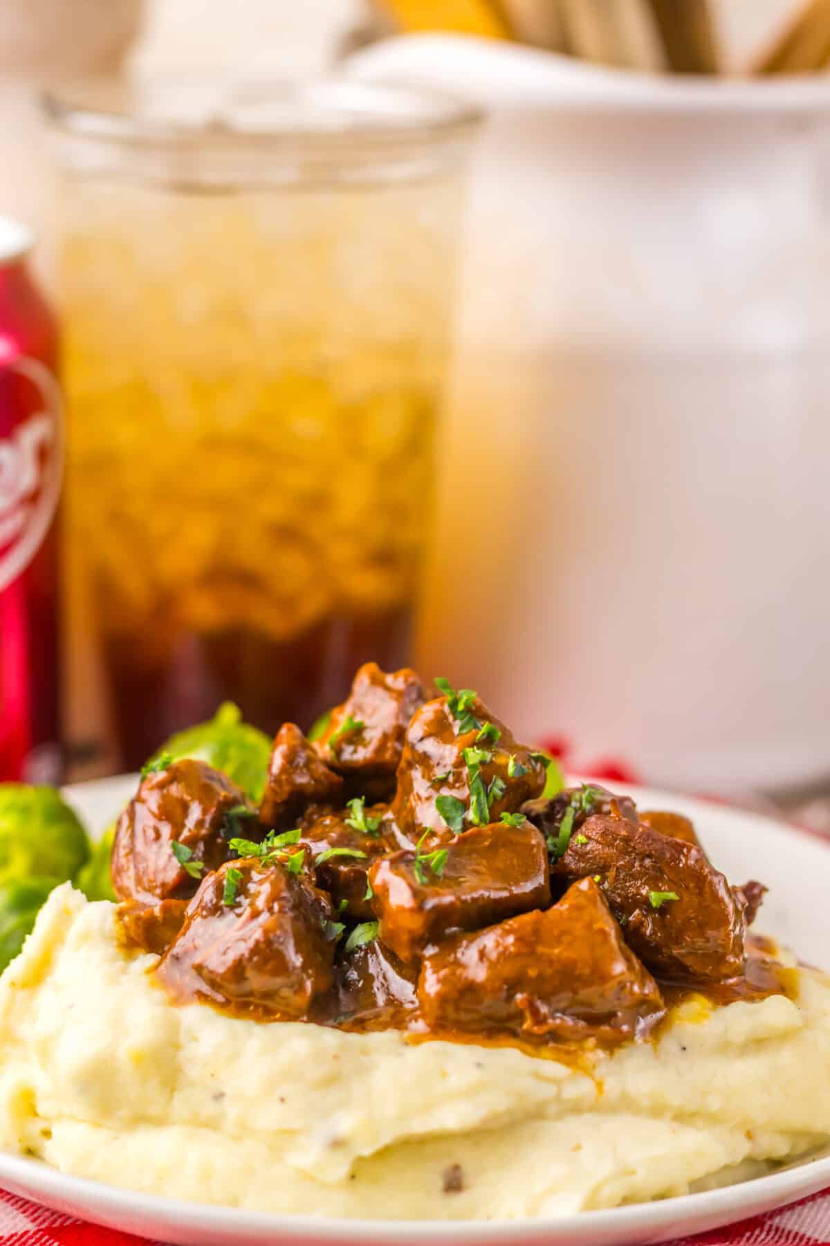 Close-up of tender slow cooker steak bites coated in sweet and savory Dr Pepper sauce.