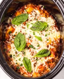 Finished slow cooker ravioli lasagna with bubbly cheese and basil