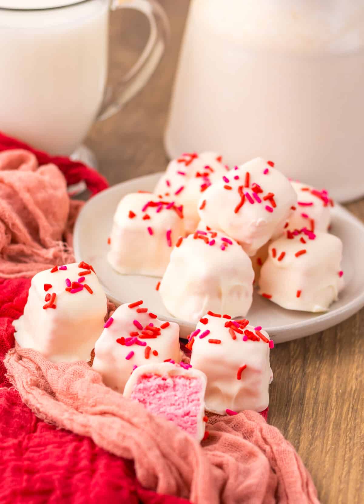 Finished strawberry Cool Whip candy cut into squares and served on a plate.