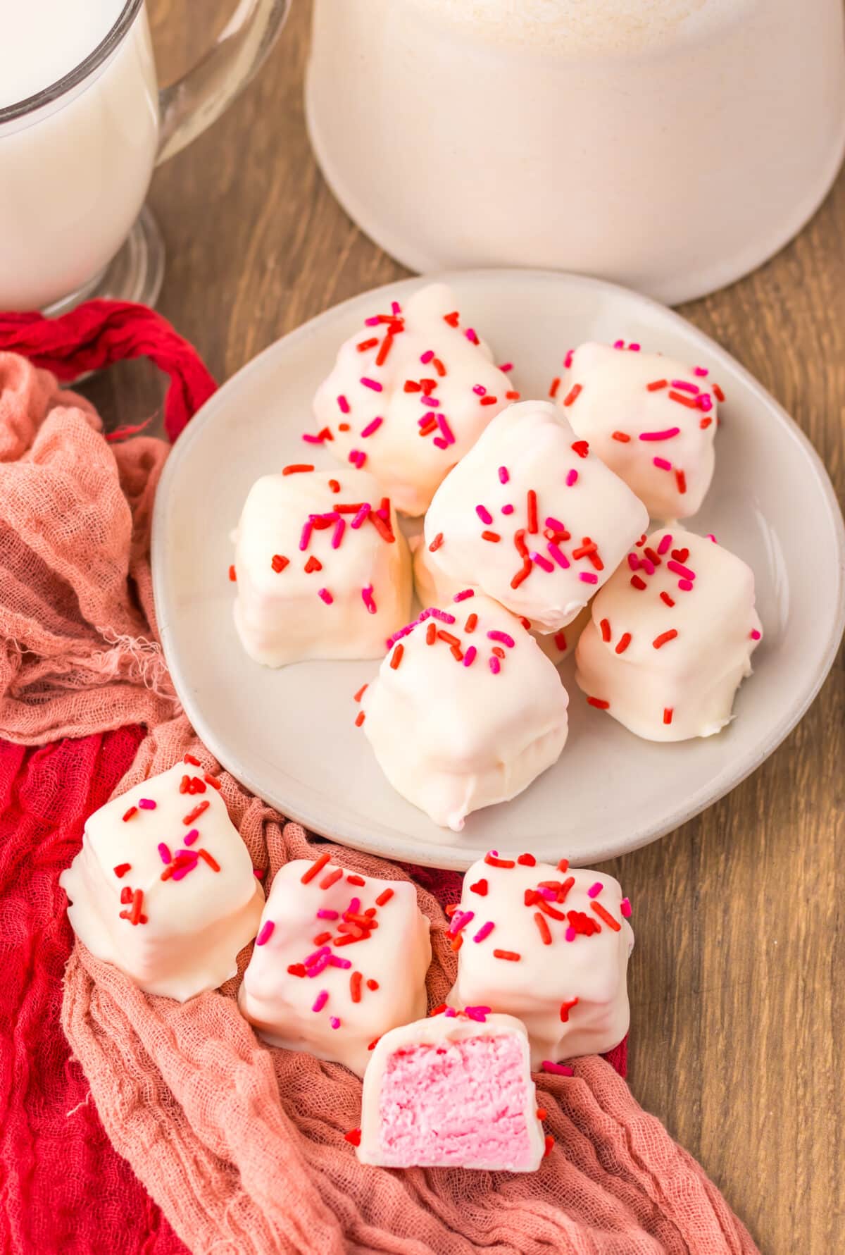 Finished strawberry Cool Whip candy cut into squares and served on a plate.