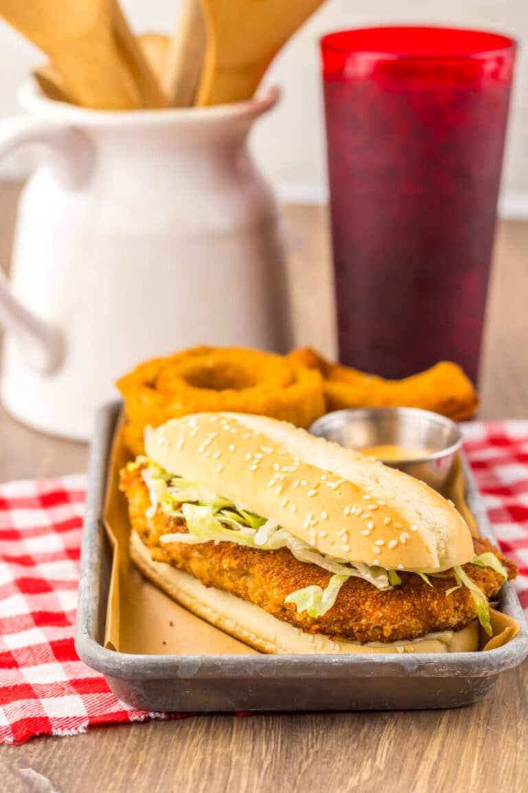Copycat Burger King Original Chicken Sandwich served with onion rings and soda.
