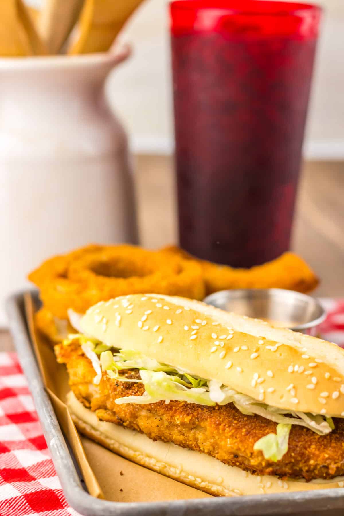 Close-up of crispy chicken sandwich showing crunchy breading and lettuce.