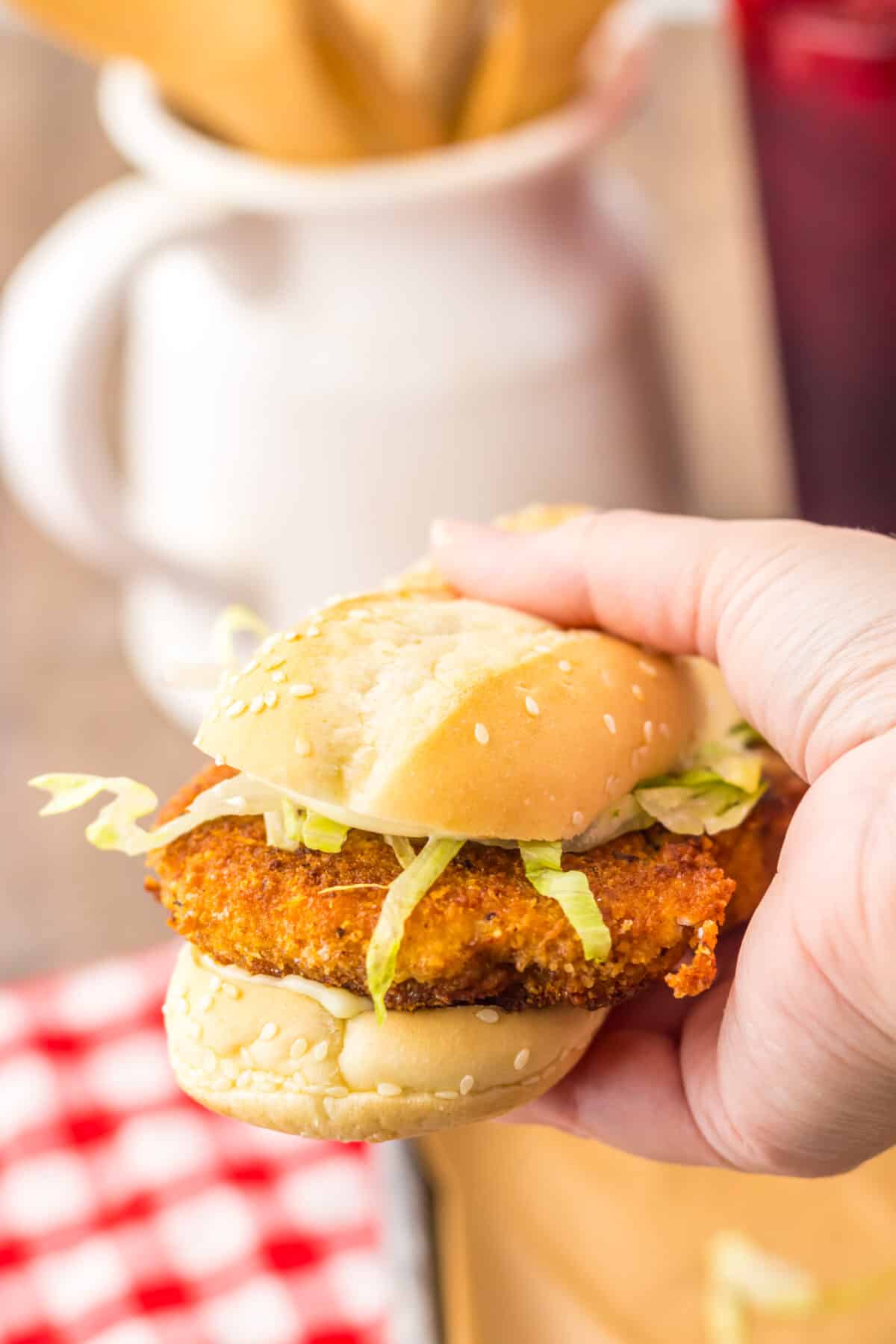 Hand holding a copycat Burger King chicken sandwich.