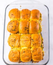 Close-up of brisket slider showing tender beef and sauce on a golden bun.