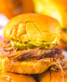 Slow cooker brisket slider served on a soft bun with tender shredded beef.