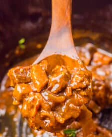Close-up of beef tips coated in thick Coca Cola gravy.