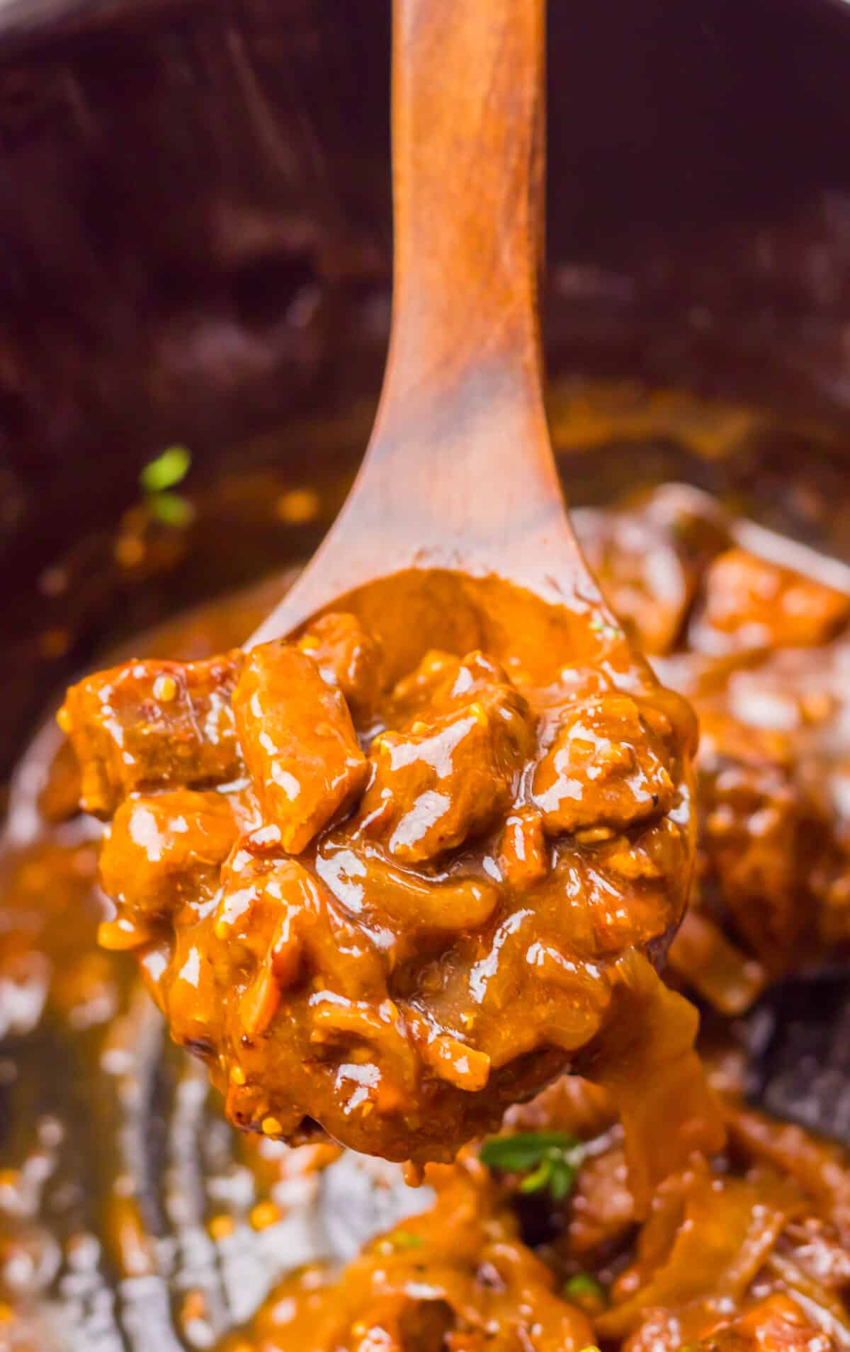 Close-up of beef tips coated in thick Coca Cola gravy.