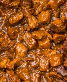 Slow cooker filled with beef tips and Coca Cola sauce after cooking.