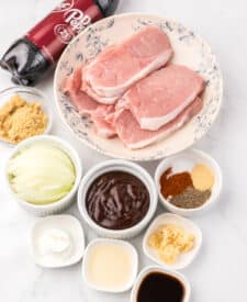 Ingredients for slow cooker Dr Pepper pork chops including pork chops, Dr Pepper, seasonings, and sauce.