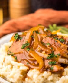Finished Dr Pepper pork chops served over mashed potatoes.