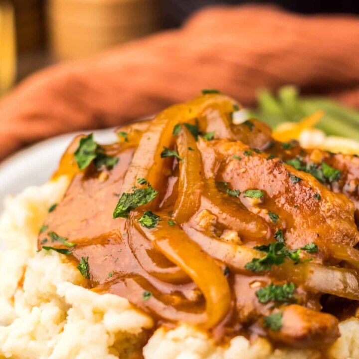 Finished Dr Pepper pork chops served over mashed potatoes.