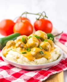 Nacho meatballs topped with melted cheese and fresh green onions.