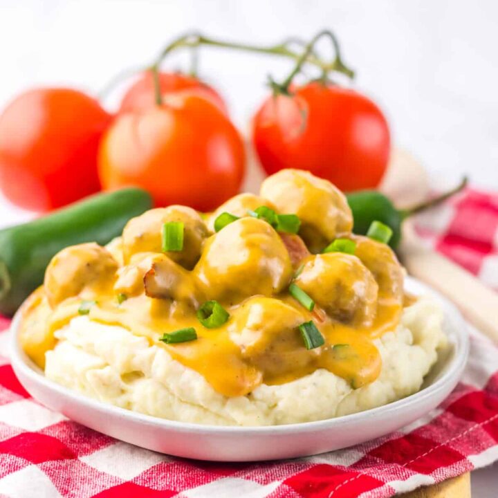 Nacho meatballs topped with melted cheese and fresh green onions.