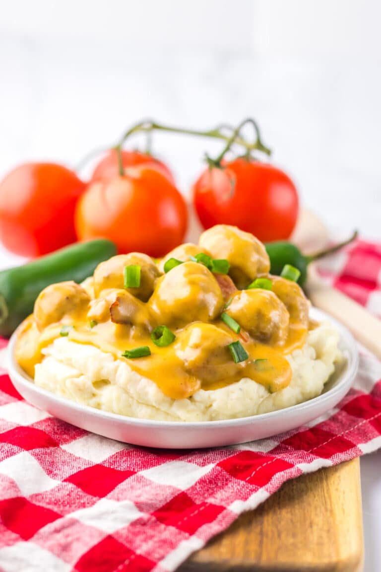 Nacho meatballs topped with melted cheese and fresh green onions.
