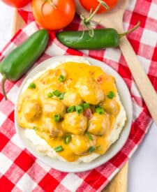 Close-up of slow cooker nacho meatballs coated in a creamy cheese sauce.