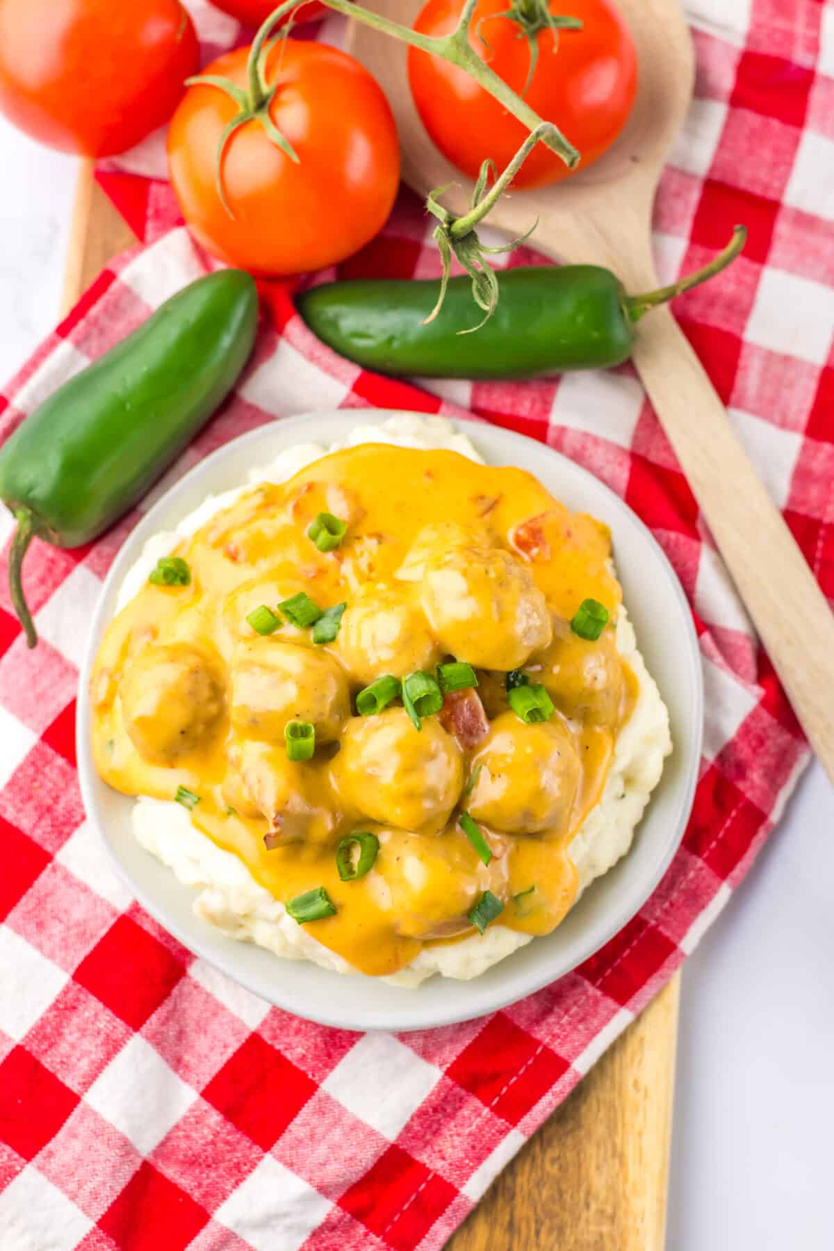 Close-up of slow cooker nacho meatballs coated in a creamy cheese sauce.