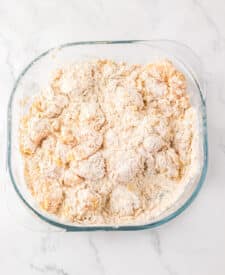 Flour-coated chicken pieces ready to fry for KFC Famous Bowls.