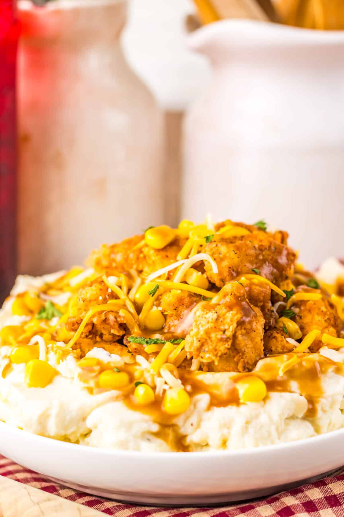 Popcorn chicken layered over mashed potatoes and corn.