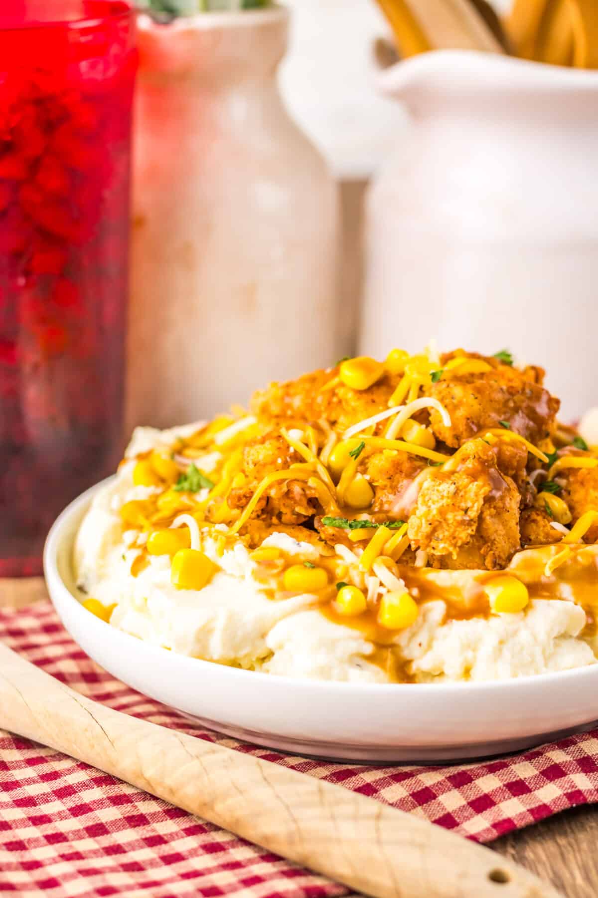 Finished copycat KFC Famous Bowl topped with shredded cheese.