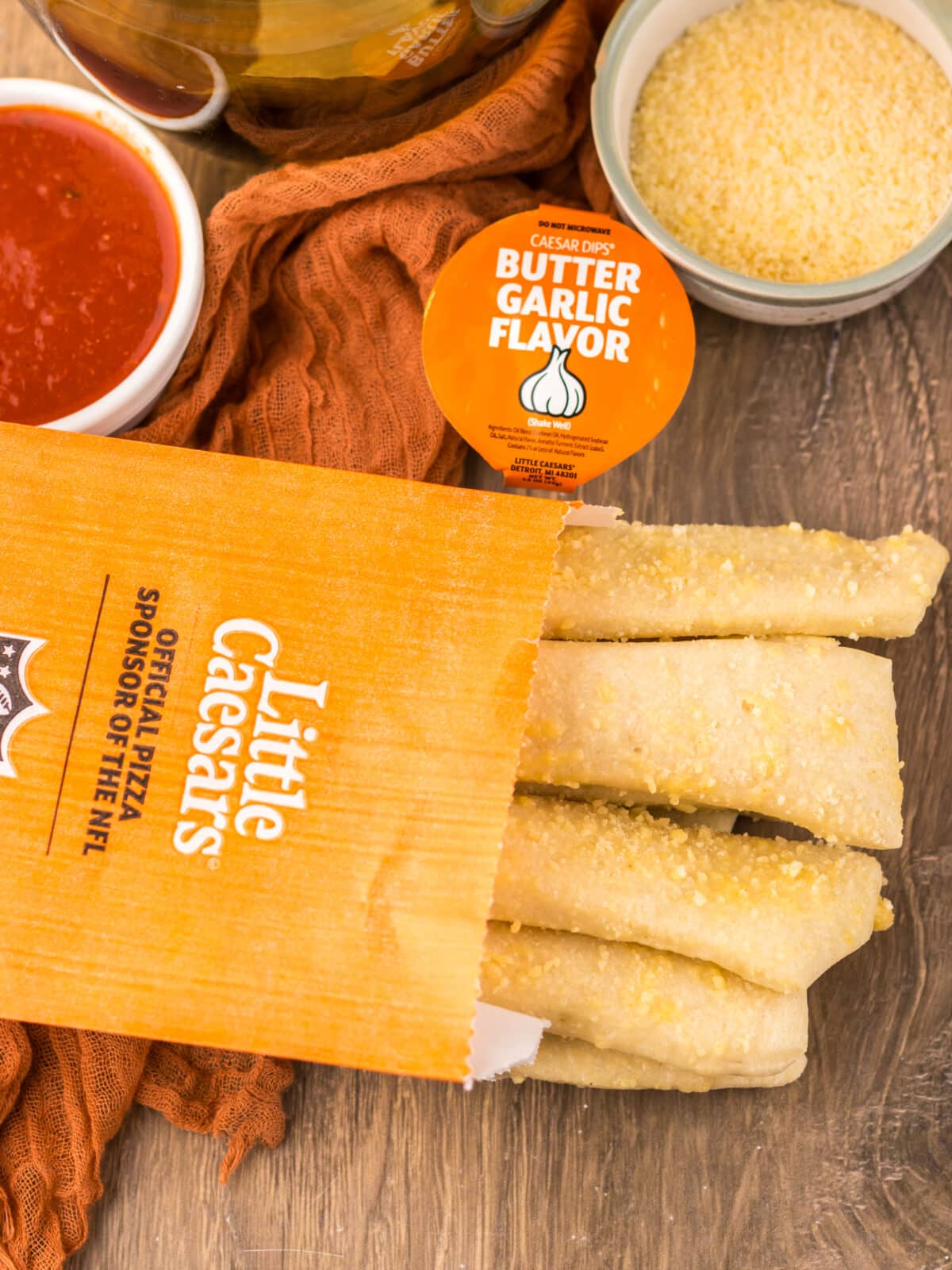 Homemade Crazy Bread sticks styled like Little Caesar’s with dipping sauces.