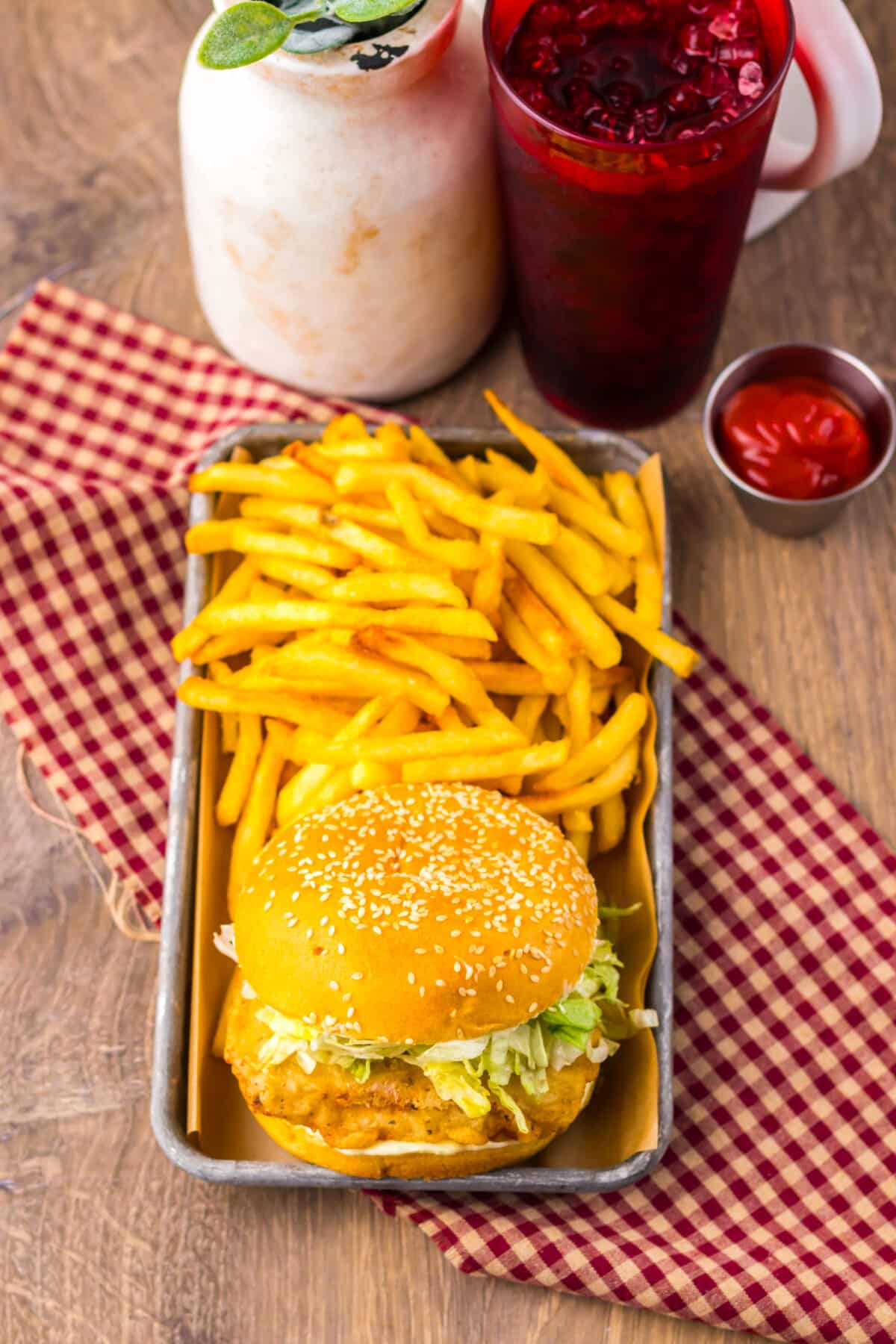Crispy McChicken sandwich served with fries on a tray.