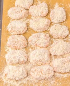 Raw spicy chicken nuggets coated in seasoned breading before frying.