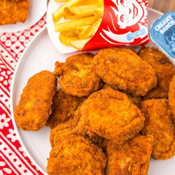 Plate of homemade Wendy’s spicy nuggets served with dipping sauces.