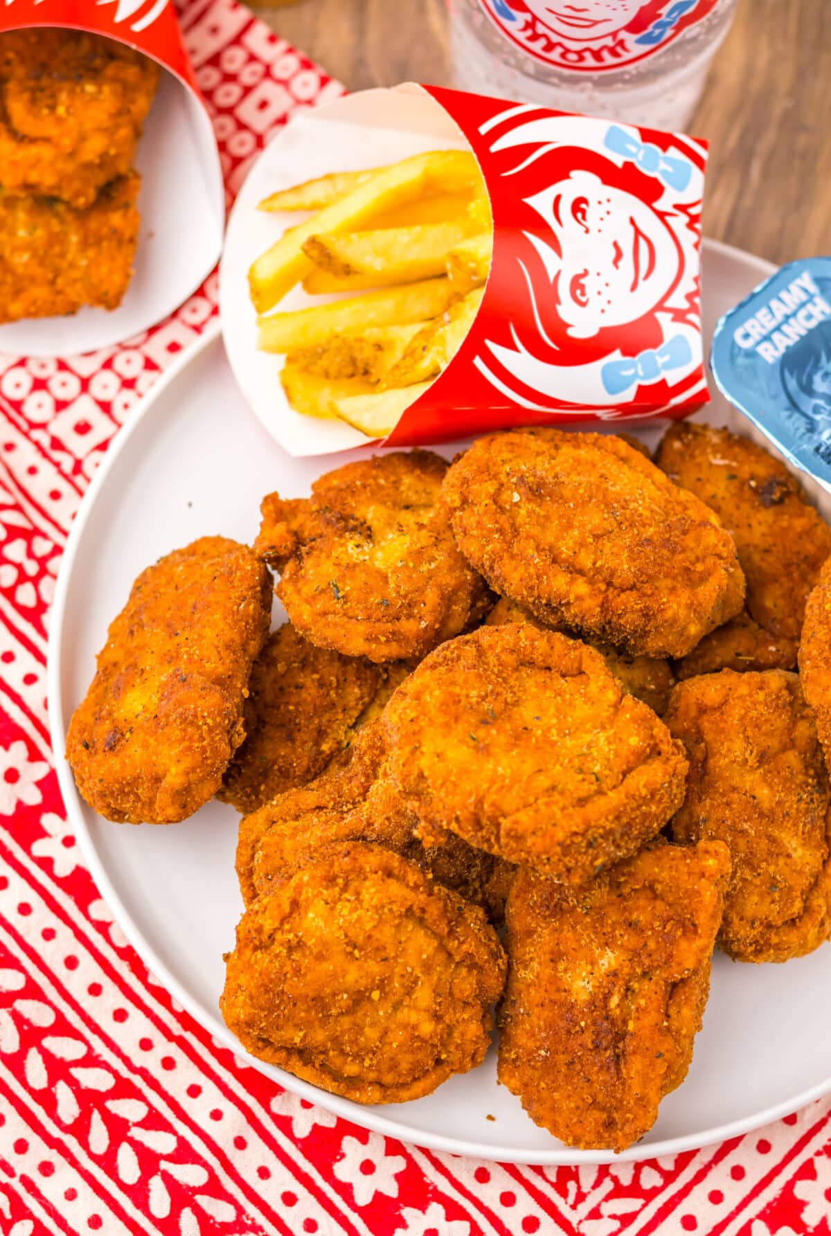 Plate of homemade Wendy’s spicy nuggets served with dipping sauces.