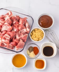 Ingredients for honey BBQ riblets including pork riblets, barbecue sauce, honey, and seasonings.