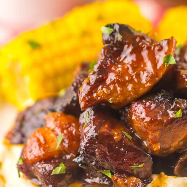 Close-up of tender honey BBQ riblets coated in sticky sauce.