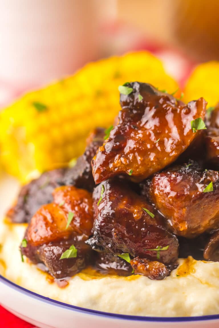 Close-up of tender honey BBQ riblets coated in sticky sauce.