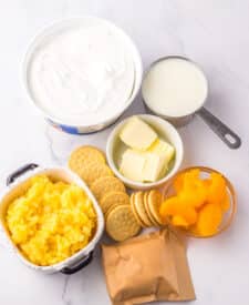 Ingredients for Pig Pickin Pie including vanilla cookies, butter, pineapple, mandarin oranges, pudding mix, milk, and whipped topping.