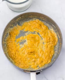 Sausage browning in a skillet for sausage gravy casserole.