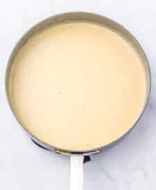 Creamy sausage gravy simmering in a skillet.