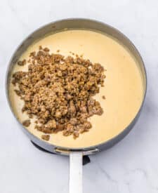 Creamy sausage gravy simmering in a skillet.