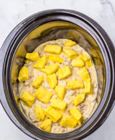 Biscuit pieces layered in the slow cooker for breakfast casserole.