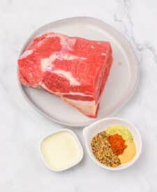 Ingredients for air fryer eye of round roast including beef roast, seasonings, and oil.