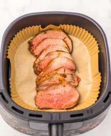 Close-up of tender sliced eye of round roast showing doneness.