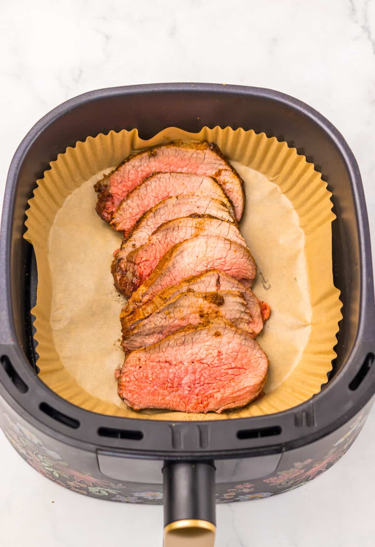 Close-up of tender sliced eye of round roast showing doneness.