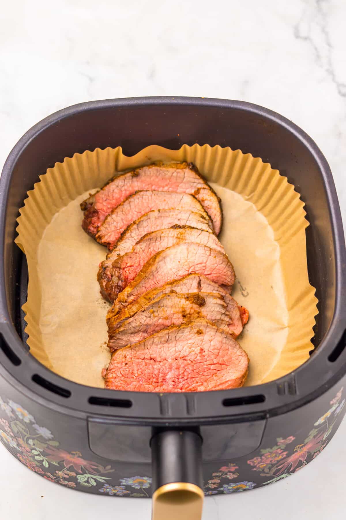 Close-up of tender sliced eye of round roast showing doneness.