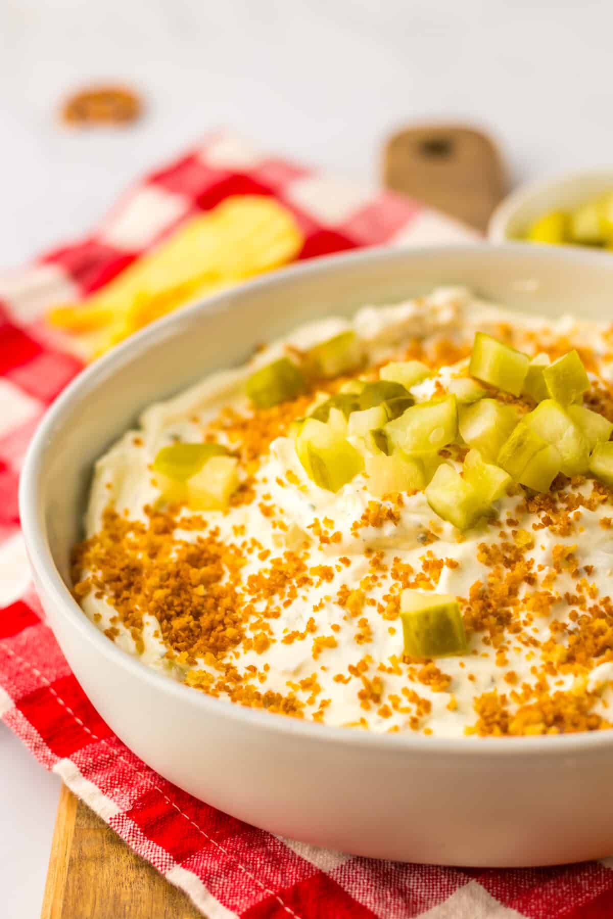 Fried pickle dip topped with crunchy breadcrumbs and diced pickles.