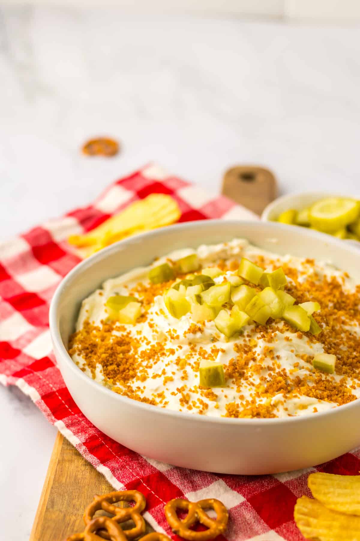 Close-up of fried pickle dip with golden breadcrumb topping.