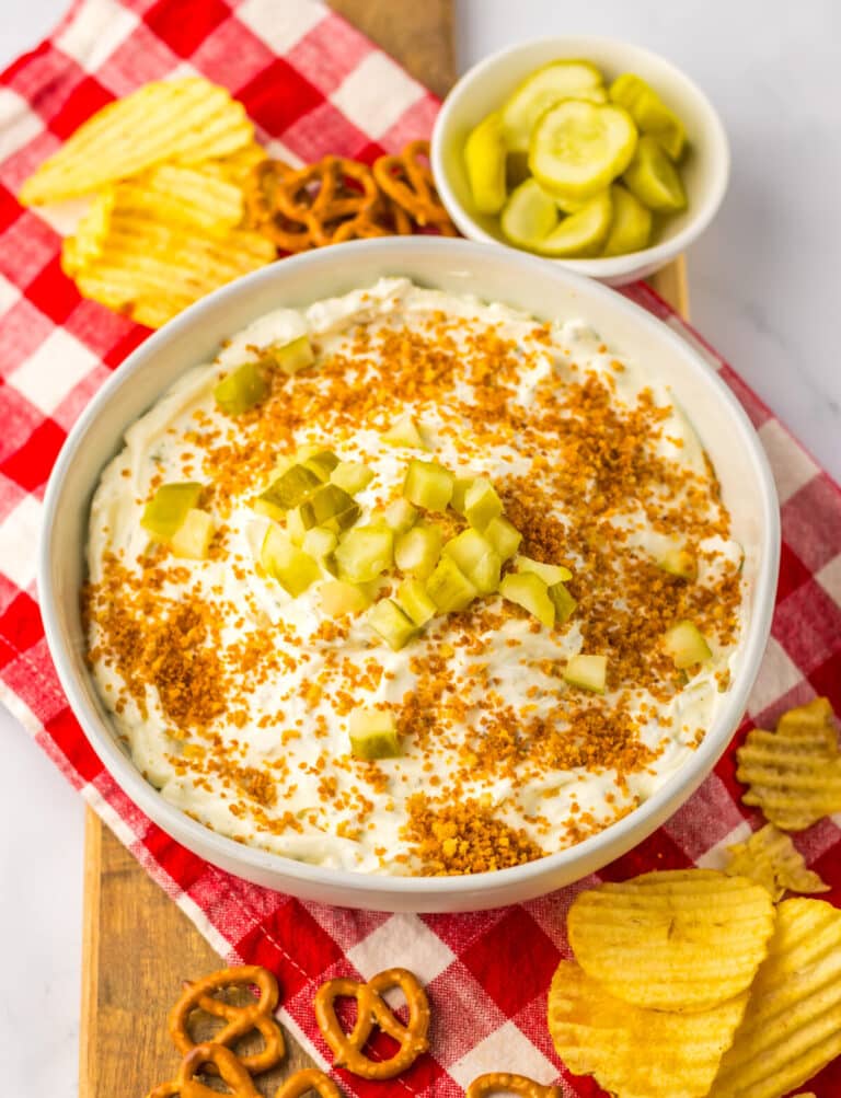 Close-up of fried pickle dip in a bowl with crispy topping.