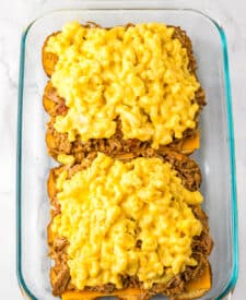 Mac and cheese layered over buns in the baking dish.
