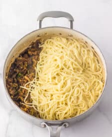 Noodles cooking in a skillet for copycat Panda Express chow mein.