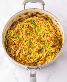 Noodles cooking in a skillet for copycat Panda Express chow mein.