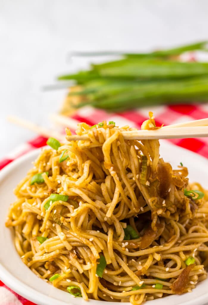 Close-up of copycat Panda Express chow mein noodles lifted with chopsticks.