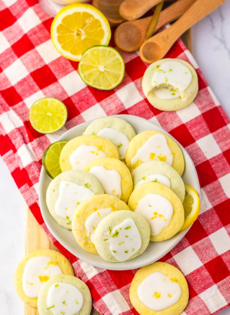 Plate of lemon lime meltaway cookies on a red checkered cloth.